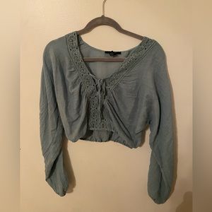 flowy, kinda see through, crisscross ties at the top and has cute lace detailing